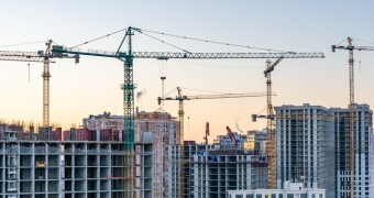 Construction site, cranes and multi storey unfinished buildings