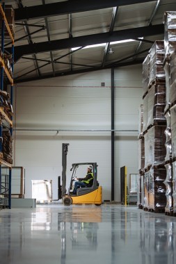 Side view of forklift in warehouse