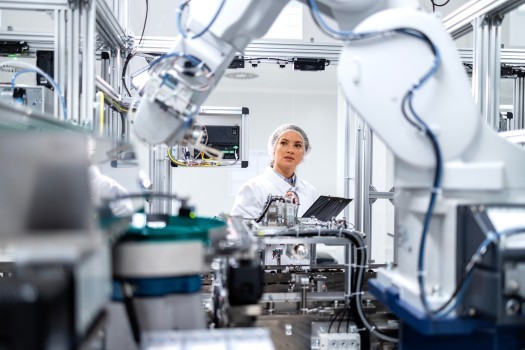 Engineer controlling production of robotic arm